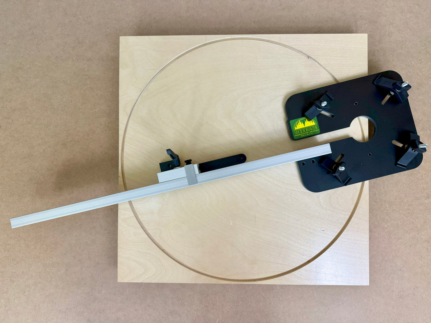 Wooden board with a circular cutout and a tool for routing circles sitting on the board