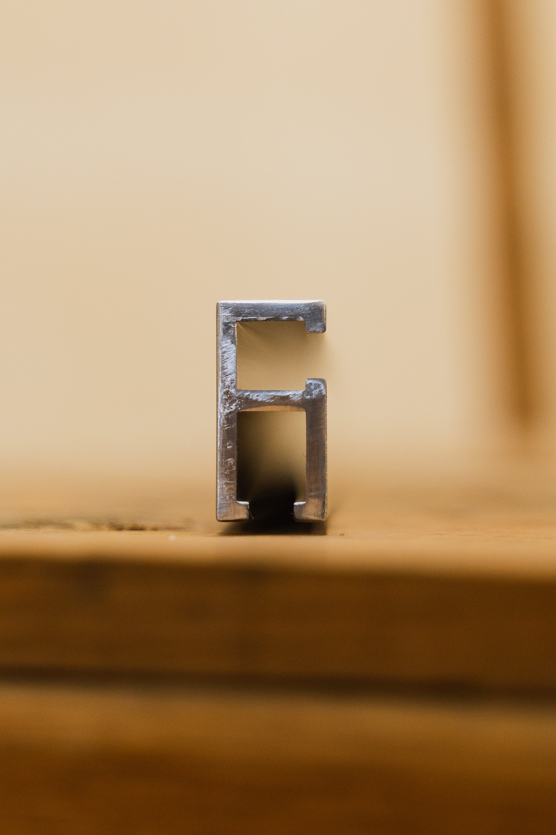 end view of A double track aluminum extrusion, typically used as a component in woodworking jigs or saw fences,  silver in color available in several lengths.