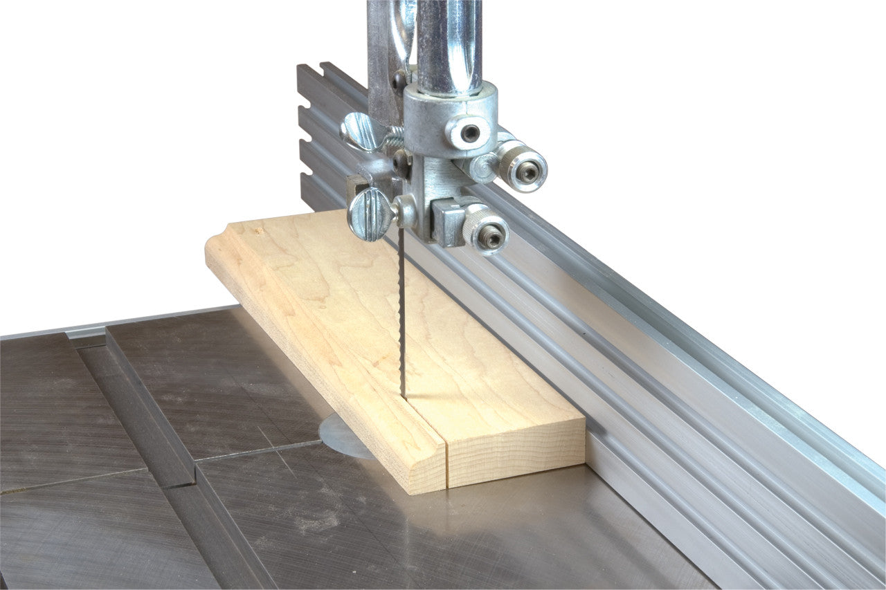 A band aw cutting a board with an upgraded fence