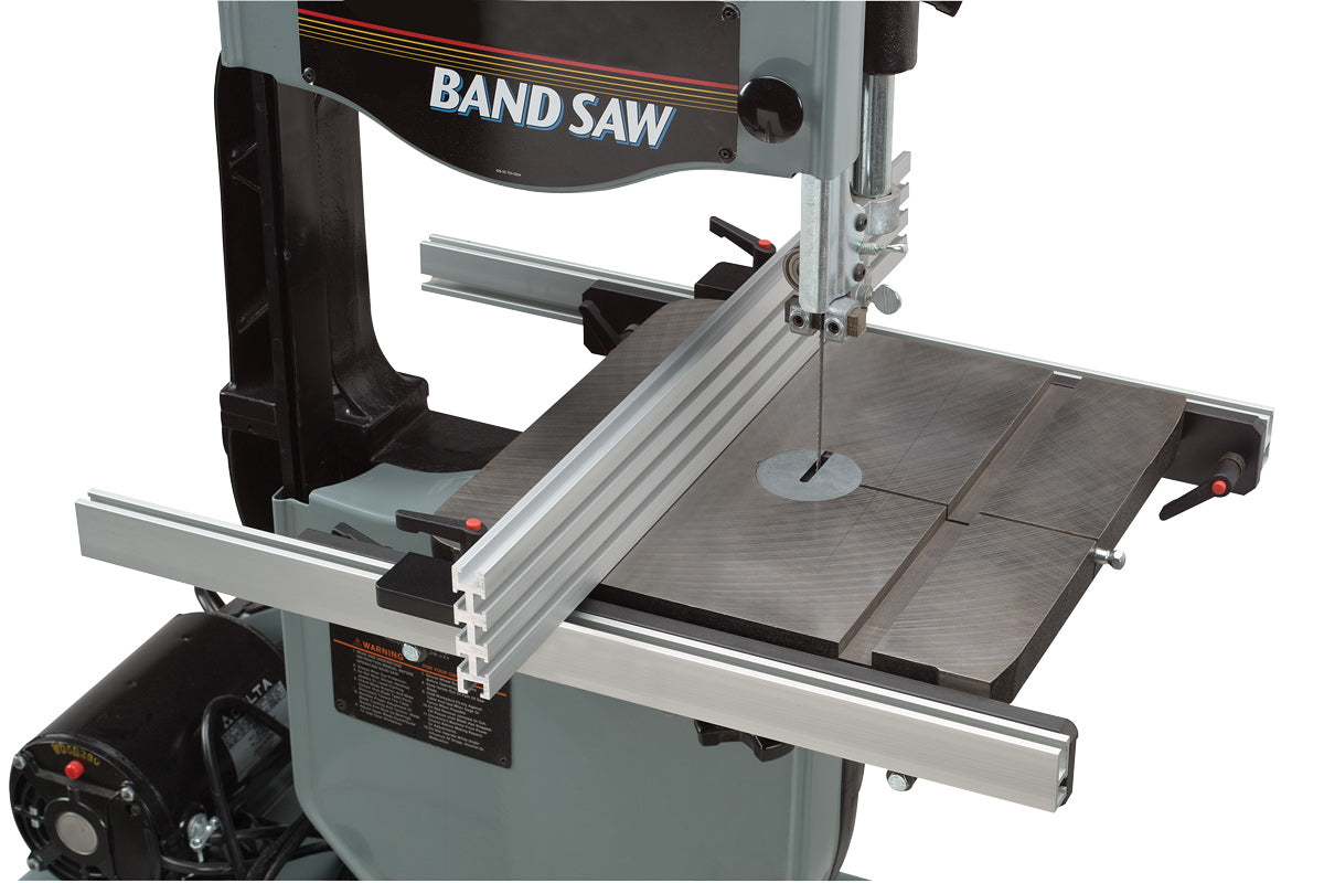 A band saw with a metal fence attached to its sides. The fence is made of aluminum and is sturdy and adjustable.
