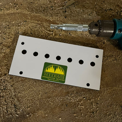 Self-centering VIX bit with brad point drill beside a Woodhaven shelf pin jig template with pilot holes